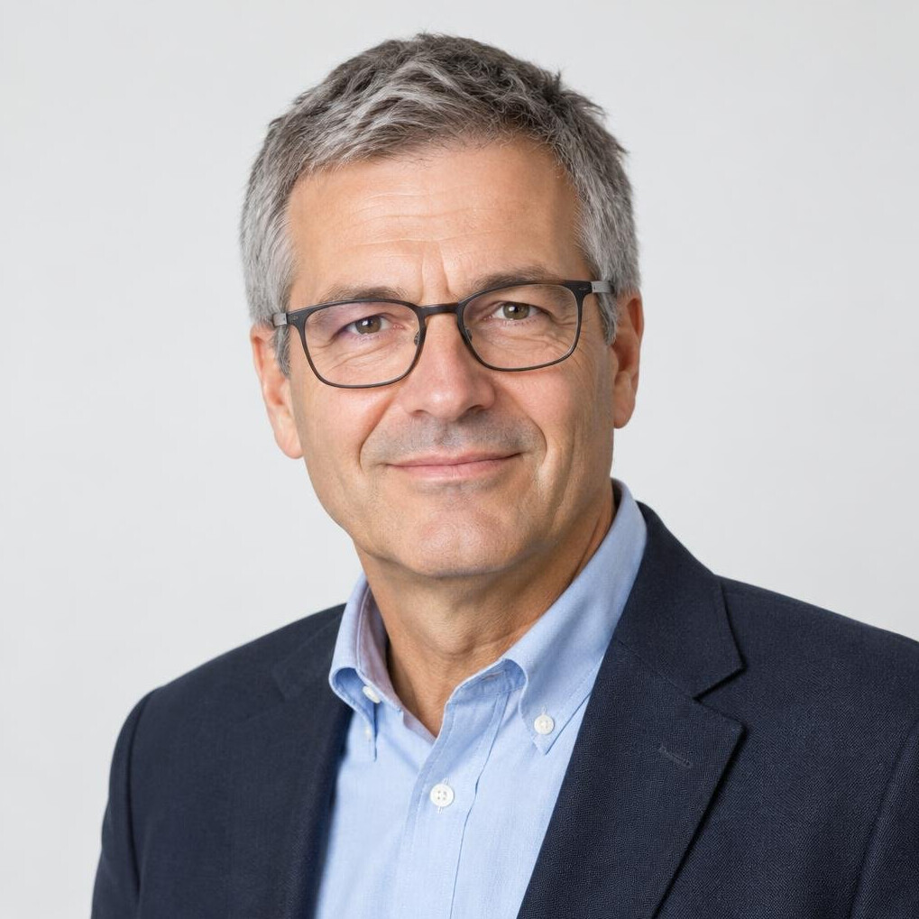 Studio portrait of a Swiss businessman in his 50s with glasses